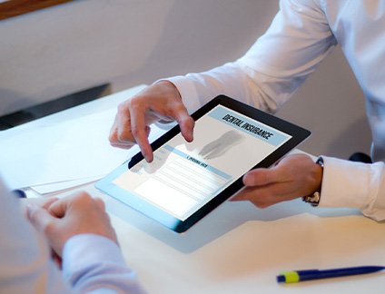 Patient reviewing dental insurance form on tablet