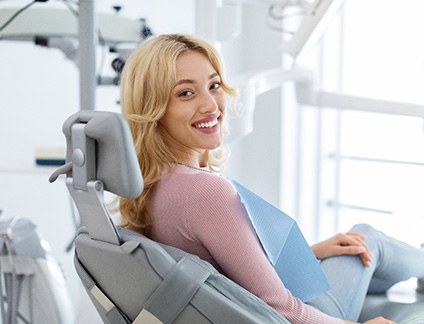 Patient smiling while sitting in treatment chair
