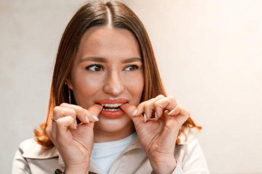 Patient putting on clear aligner in treatment room