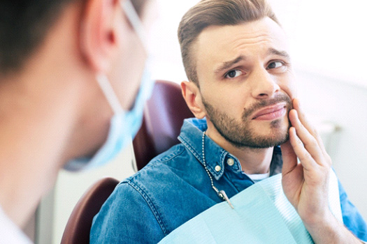 Patient with toothache looking at dentist