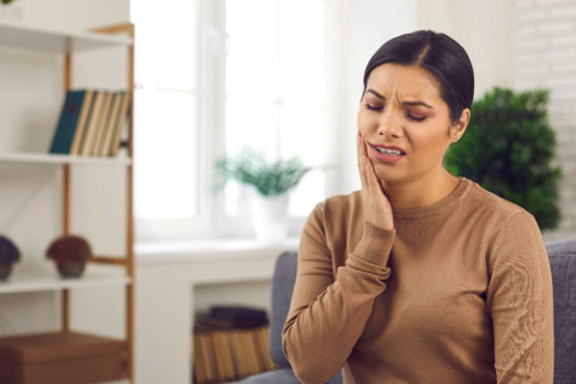 Closeup of woman experiencing toothache at home